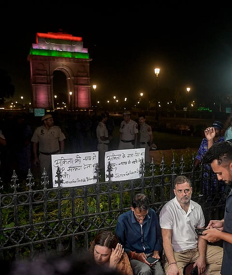 Lok Sabha Leader of Opposition (LoP) Rahul Gandhi with the parents of Ankita Bhandari during a sit-in protest at India Gate, in New Delhi, Wednesday, Oct. 14, 2026. LoP Rahul Gandhi and Priyanka Gandhi joined the family to express solidarity with their demand to put on hold the gubernatorial appointment of a BJP leader whose name they allege is linked to the case.