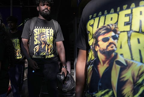 Fans of Indian superstar Rajinikanth wear T-shirts bearing his image as they arrive for a screening of his latest film, "Jailer 2," at a cinema hall in Mumbai, India, Thursday, Oct. 15, 2026. 