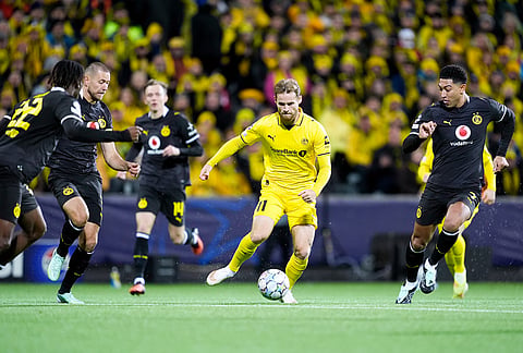 Bodo's Ole Didrik Blomberg, center, and Dortmund's Jobe Bellingham, right, during the Champions League soccer match between Bodo/Glimt and Borussia Dortmund in Bodo, Norway, Wednesday, Oct. 14, 2026. 
