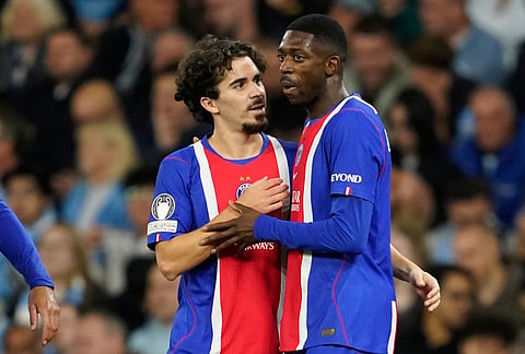PSG's Ousmane Dembele, right, celebrates with PSG's Vitinha after scoring his side's second goal during the Champions League opening phase soccer match between Manchester City and Paris Saint-Germain in Manchester, England, Wednesday, Oct. 14, 2026.