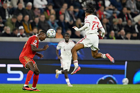 LASK's Yvan Dibango, left, heads the ball as Liverpool's Rio Ngumoha jumps during the Champions League opening phase soccer match between LASK and Liverpool in Linz, Austria, Wednesday, Oct. 14, 2026.
