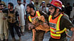 In Photos: Children Rescued From Rubble As Families Mourn After Peshawar School Roof Collapse | Photo: AP/Muhammad Zubair : Rescue workers carry an injured boy after rescuing him from the rubble of a roof collapse at a private school, in Peshawar, Pakistan, Thursday, Oct. 15, 2026.