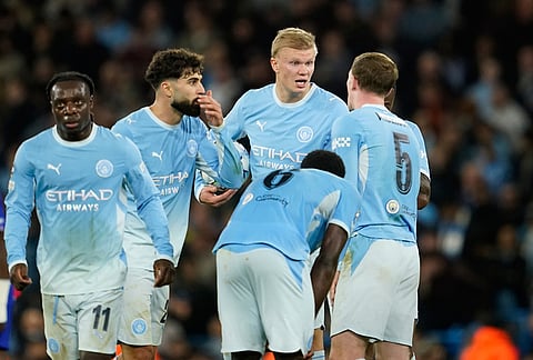 Manchester City's Erling Haaland, center right, talks to his team mates after PSG's Vitinha scored their third goal during the Champions League opening phase soccer match between Manchester City and Paris Saint-Germain in Manchester, England, Wednesday, Oct. 14, 2026. 
