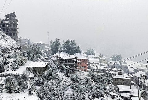 Houses blanketed in a layer of fresh snow following a spell of snowfall, in Keylong, Lahaul-Spiti district, Himachal Pradesh, Thursday, Oct. 15, 2026. 