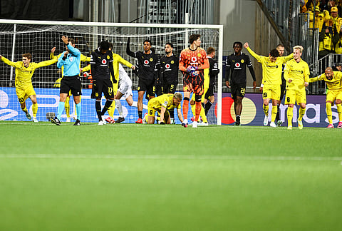 Bodo's players celebrate after winning the Champions League soccer match between Bodo/Glimt and Borussia Dortmund in Bodo, Norway, Wednesday, Oct. 14, 2026.