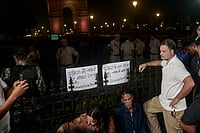 Photo: PTI  : Lok Sabha Leader of Opposition (LoP) Rahul Gandhi with the parents of Ankita Bhandari during a sit-in protest at India Gate, in New Delhi, Wednesday, Oct. 14, 2026. LoP Rahul Gandhi and Priyanka Gandhi joined the family to express solidarity with their demand to put on hold the gubernatorial appointment of a BJP leader whose name they allege is linked to the case.