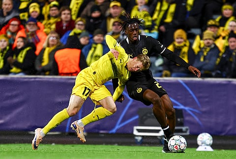 Bodo's Ola Brynhildse, left, and Dortmund's Joane Gadou during the Champions League soccer match between Bodo/Glimt and Borussia Dortmund in Bodo, Norway, Wednesday, Oct. 14, 2026. 
