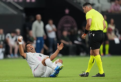 Inter Miami forward Luis Suárez, left, falls to the field during the first half of an MLS soccer match against New York City FC, Wednesday, Oct. 14, 2026, in Miami. 