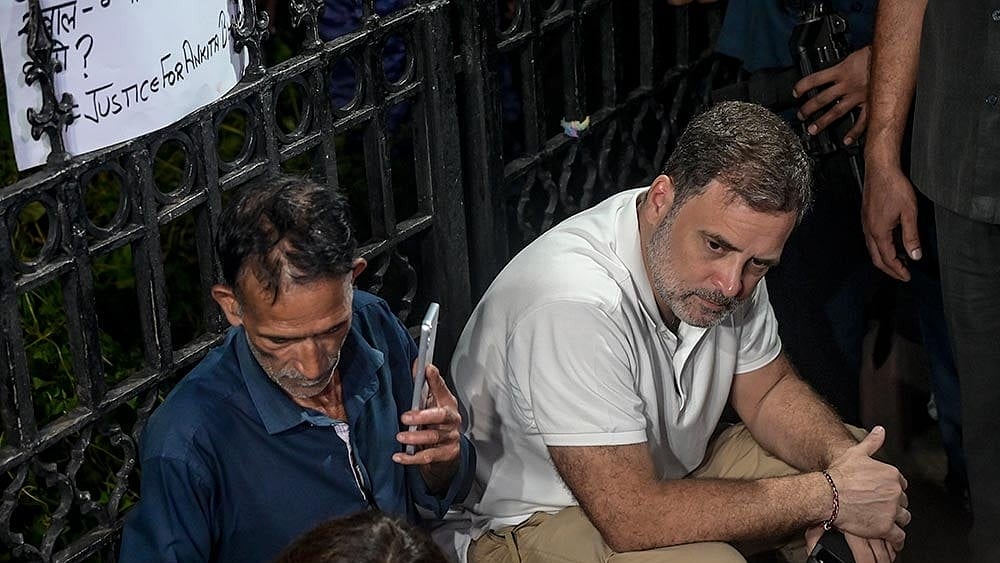 Lok Sabha Leader of Opposition (LoP) Rahul Gandhi with the parents of Ankita Bhandari during a sit-in protest at India Gate, in New Delhi, Wednesday, Oct. 14, 2026. LoP Rahul Gandhi and Priyanka Gandhi joined the family to express solidarity with their demand to put on hold the gubernatorial appointment of a BJP leader whose name they allege is linked to the case. - Photo: PTI