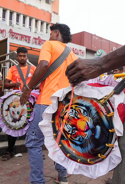 Dhakis, traditional Bengali drummers, display their skills as they arrive at Sealdah railway station from rural areas, hoping to be hired by Durga Puja committees for the remaining four days of the festival, in Kolkata, West Bengal, Thursday, Oct. 15, 2026.