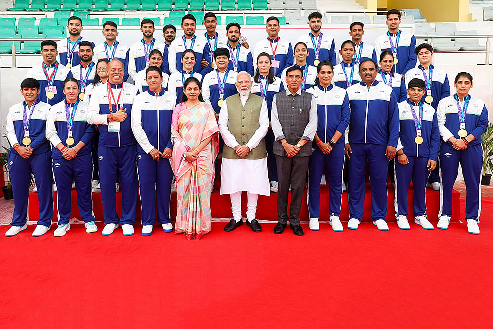In this image released on Oct. 15, 2026, Prime Minister Narendra Modi, Youth Affairs and Sports Minister Mansukh Mandaviya and others during a meeting with participants of the Aichi-Nagoya 2026 Asian Games, in New Delhi. - | Photo: narendramodi.in via PTI 