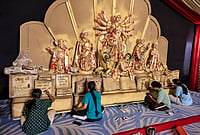 In Photos: Poetry, Coal Mines And Calendars Inspire Durga Puja Pandals | Photo: PTI : Children prepare installations at a committee Durga Puja 'pandal' themed on Bengali Literature amid the ongoing festival, in Jaipur, Rajasthan, Thursday, Oct. 15, 2026.