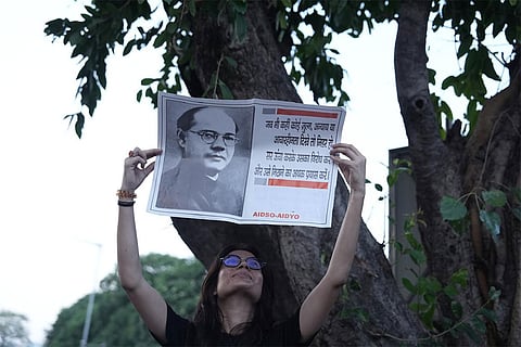 People participate in the 'Lehra Do Tiranga' protest march called by the Cockroach Janta Party (CJP) demanding the resignation of Chief Election Commissioner (CEC) Gyanesh Kumar over alleged irregularities in the Special Intensive Revision (SIR) of electoral rolls, at Connaught Place, in New Delhi, Friday, Oct. 16, 2026.