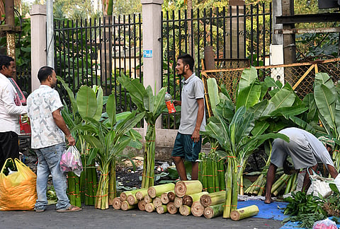 People interact with a vendor as they shop during the Durga Puja festival, in Guwahati.