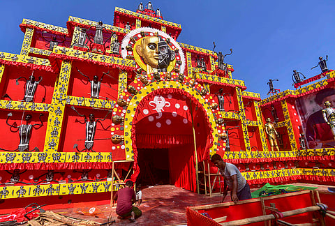 Workers assemble a Durga Puja pandal, themed as “The Illusion of Machines”, ahead of the festival, in Nagaon district, Assam, Monday, Oct. 12, 2026. 
