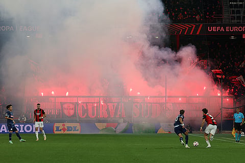 AC Milan supporters light flares during an Europa League opening phase soccer match between FC Red Bull Salzburg and AC Milan, in Salzburg, Austria, Thursday, Oct.15, 2026.