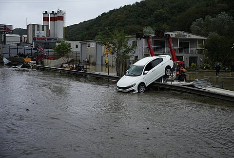 A car lies toppled in the aftermath of floods caused by heavy rains in Istanbul, Turkey, Thursday, Oct. 15, 2026. 