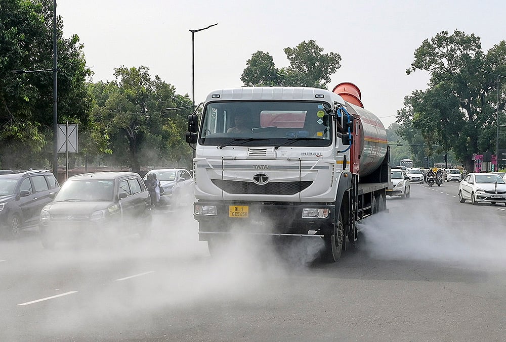 A sprinkler truck sprays water