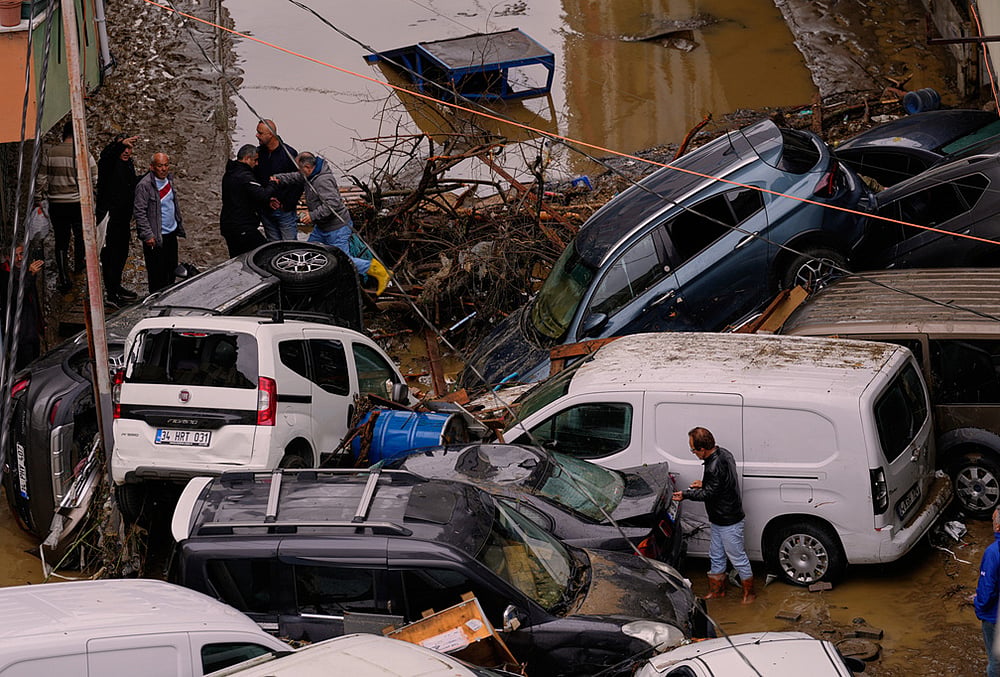Local residents walk among toppled vehicles and scattered debris in the aftermath of floods caused by heavy rains, in Istanbul, Turkey, Thursday, Oct. 15, 2026. 
 - | Photo: AP/Emrah Gurel