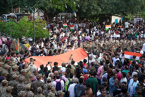 People participate in the 'Lehra Do Tiranga' protest march called by called by the Cockroach Janta Party (CJP) demanding the resignation of Chief Election Commissioner (CEC) Gyanesh Kumar over alleged irregularities in the Special Intensive Revision (SIR) of electoral rolls, at Connaught Place, in New Delhi, Friday, Oct. 16, 2026.