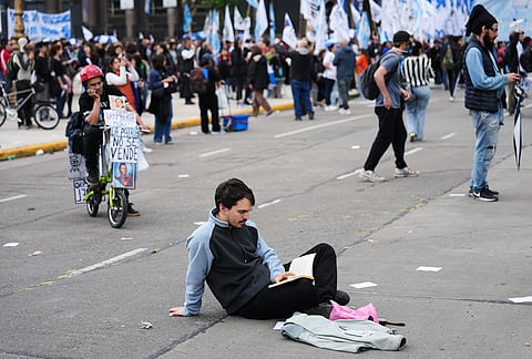 A demonstrator reads during an anti-government protest in Buenos Aires, Argentina, Thursday, Oct. 15, 2026. 
