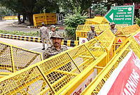 | Photo: PTI  : Police personnel stand near barricades ahead of a Tiranga March rally by Cockroach Janata Party (CJP), at Tolstoy Marg, in New Delhi.