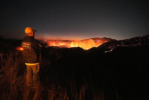 The Bryson Fire illuminates a ridge top on Thursday, Oct. 15, 2026, in Malibu, California. 
