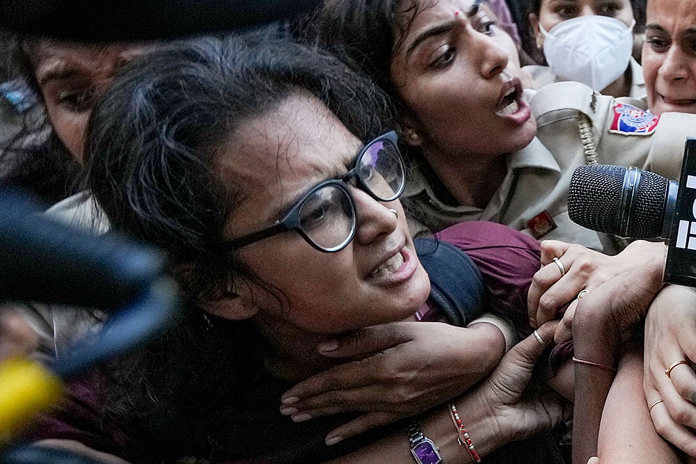 AISA chief Neha Bora is detained by the police during a protest against Chief Election Commissioner (CEC) Gyanesh Kumar, demanding his resignation over alleged irregularities in the Special Intensive Revision (SIR) of electoral rolls, at Mandi House, in New Delhi, Friday, Oct. 16, 2026. - | Photo: PTI/Arun Sharma