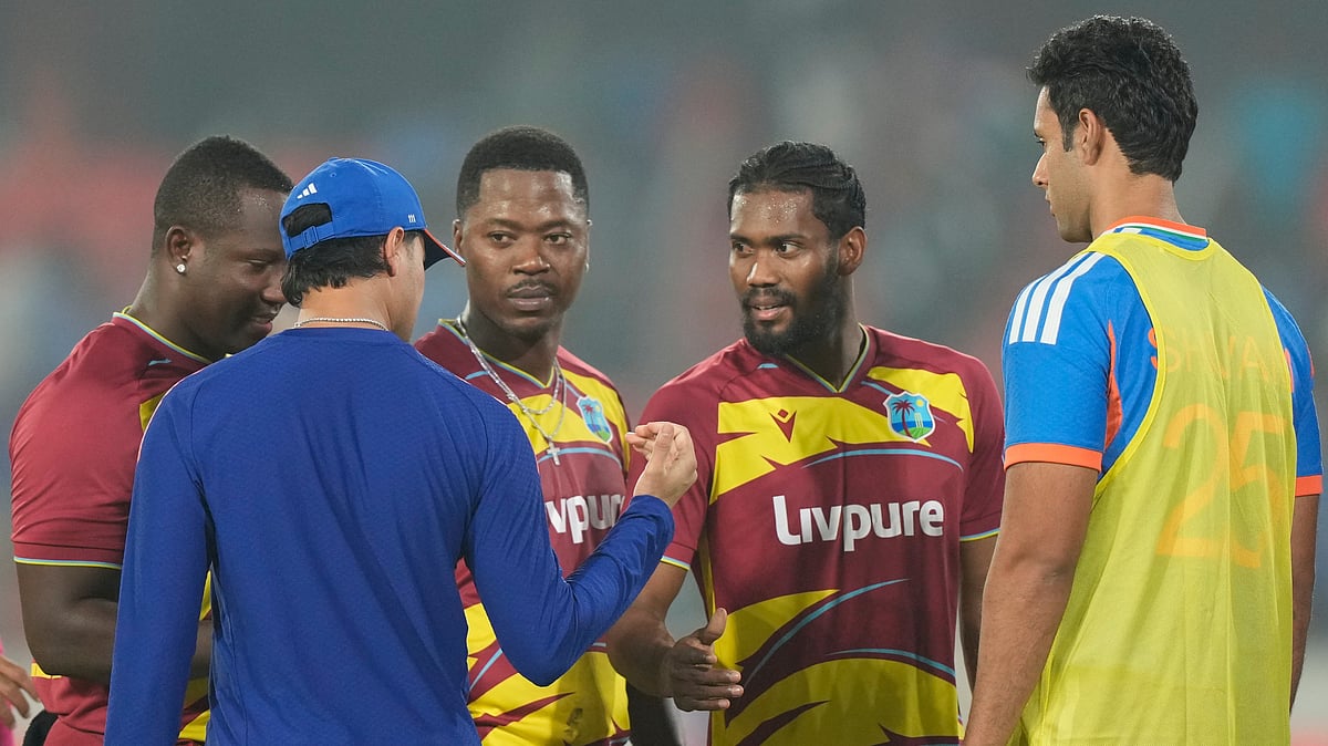 India's Abhishek Sharma, second left, talks with West Indies' Keemo Paul, second right, while hand shake after West Indies won the fourth T20 cricket match against India in Hyderabad, India, Wednesday, Oct. 14, 2026 - (AP Photo/Mahesh Kumar A.)