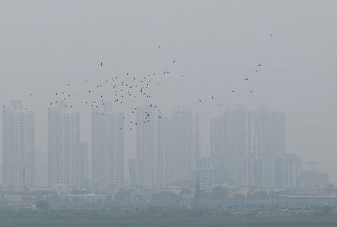 Buildings remain shrouded amid hazy conditions following rainfall. in Gurugram, Haryana.