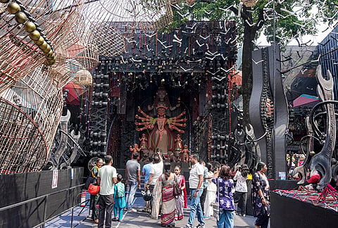 People visit a community 'Durga Puja' pandal on the occasion of 'Maha Sasthi', in Kolkata, West Bengal.