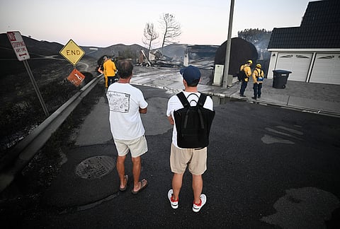 Residents look over houses that burned during the Norte Fire on Friday, Oct. 16, 2026, in San Juan Capistrano, California.
