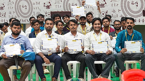 Selected candidates display their job offer letters during the State-Level Rozgaar Mela 2026, organized by the Chhattisgarh government under Chief Minister Vishnu Deo Sai to boost youth employment and skill development, in Raipur. 