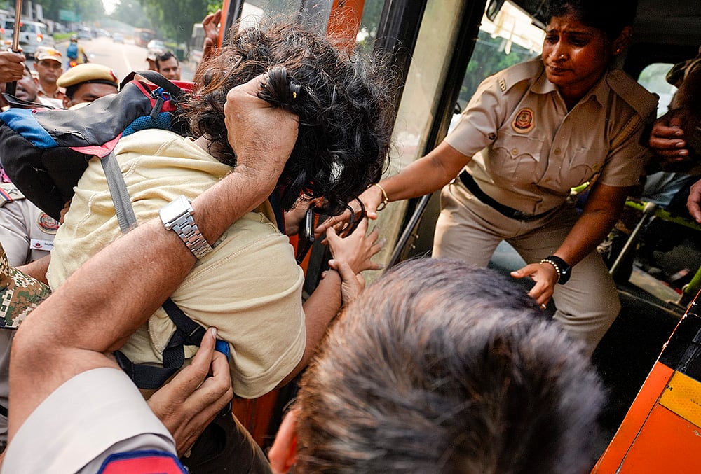 Police personnel detain a demonstrator during a protest march, demanding resignation of Chief Election Commissioner (CEC) Gyanesh Kumar, amid a demonstration organized by Justice Morcha, in New Delhi, Saturday, Oct. 17, 2026. 
 - | Photo: PTI/Ravi Choudharay