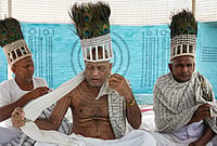 In Photos: Ramnami Community From Chhattisgarh Brings Its Devotion To Kolkata's Durga Puja | Photo: PTI/Swapan Mahapatra : Members of the Ramnami community, a Hindu devotional sect from Chhattisgarh, are seen at a community puja pandal during the ongoing 'Durga Puja' festival, in Kolkata, West Bengal, Saturday, Oct. 17, 2026. The community members tattoo the sacred name 'Ram' on their skin, transforming their bodies into living temples, as an act of rebellion against discrimination by the higher castes.
