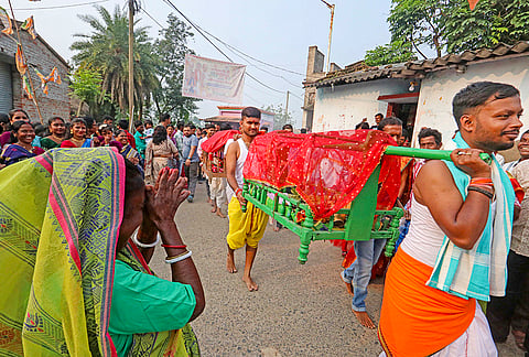 People return in a procession after performing 'Kolabou Snan' rituals on the occasion of 'Maha Saptami' during the ongoing 'Durga Puja' festival, at Hatserandi village, in Birbhum, West Bengal, Saturday, Oct. 17, 2026. 
