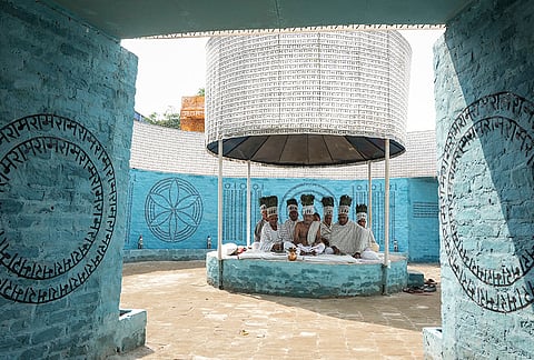 Members of the Ramnami community, a Hindu devotional sect from Chhattisgarh, are seen at a community puja pandal during the ongoing 'Durga Puja' festival, in Kolkata, West Bengal, Saturday, Oct. 17, 2026. The community members tattoo the sacred name 'Ram' on their skin, transforming their bodies into living temples, as an act of rebellion against discrimination by the higher castes. 
