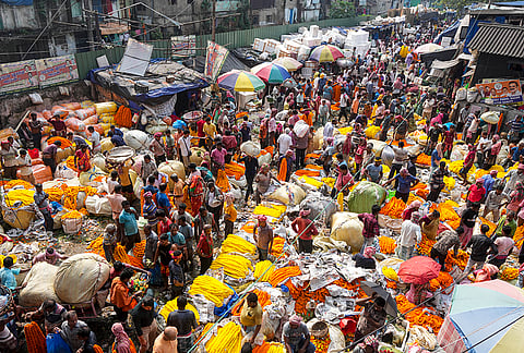 People throng a wholesale flower market during the ongoing 'Durga Puja' festival, in Kolkata, West Bengal, Saturday, Oct. 17, 2026. 
