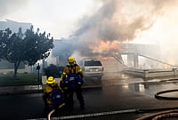 California Wildfires In Photos: Firefighters Battle Norte Fire As Flames Threaten Homes | Photo: Paul Bersebach/The Orange County Register via AP : Firefighters work to save structures on Via La Mirada during the Norte fire in San Clemente, California on Friday, Oct. 16, 2026.