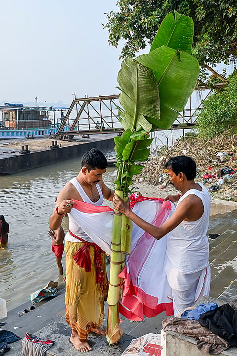 People perform 'Kolabou Snan' rituals in the Hooghly river on the occasion of 'Maha Saptami' during the ongoing 'Durga Puja' festival, in Nadia, West Bengal, Saturday, Oct. 17, 2026. 
