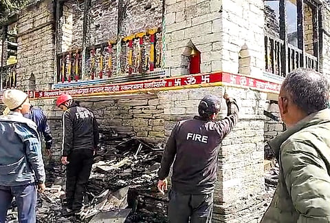 Firemen inspect the area after a fire broke out at the Ma Bhagwati temple, an ancient wooden temple dedicated to Goddess Bhagwati, at Badiyakot area in Bageshwar district, Uttarakhand, Friday, Oct. 16, 2026. 
