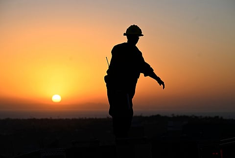 A firefighter stands on the roof of his engine as he prepares to leave the Norte Fire on Friday, Oct. 16, 2026, in San Juan Capistrano, California. 
