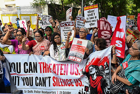 Women hold placards as they take part in a march against the alleged police brutality on women protestors, in New Delhi, Saturday, Oct. 17, 2026. 
