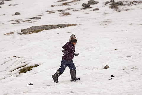 A child plays in snow at Zero Point Zojila on the Srinagar-Leh National Highway, in Jammu and Kashmir, Saturday, Oct. 17, 2026. 
