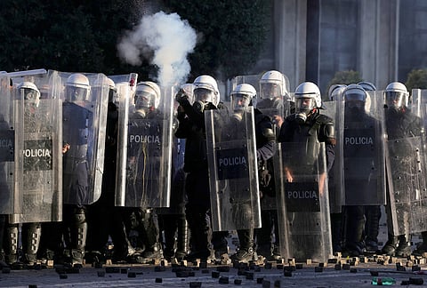 Riot police fire tear gas at protesters during an anti-government demonstration in Tirana, Albania, Friday, Oct. 16, 2026. 
