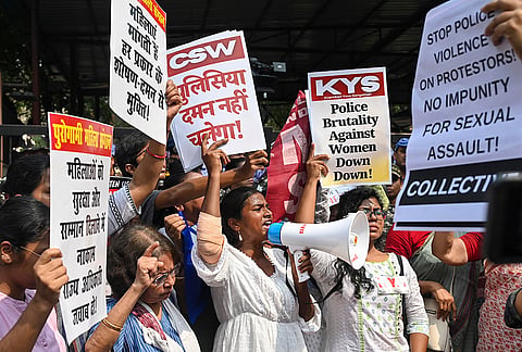 Women hold placards as they take part in a march against the alleged police brutality on women protestors, in New Delhi, Saturday, Oct. 17, 2026. 
