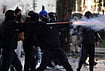 | Photo: AP/Hameraldi Agolli : A hooded protester uses fireworks against riot police during an anti-government demonstration in Tirana, Albania, Friday, Oct. 16, 2026. 
