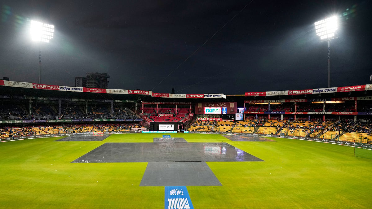The playing surface is protected from the rain at M Chinnaswamy Stadium before the start of the fifth T20 cricket match between India and West Indies in Bengaluru, India, Saturday, Oct. 17, 2026 - (AP Photo/Aijaz Rahi)