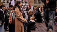 | Photo: AP/Andreea Alexandru : A woman holds hands with a child during a protest aiming to raise awareness to the violence and prejudice against women in Romanian society, in Bucharest, Romania, Saturday, Oct. 17, 2026.
