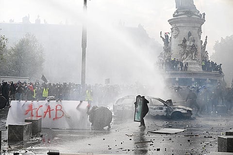 Protesters confront police during a demonstration against rising living costs and in support of students’ grievances in Paris, Saturday, Oct. 17, 2026.
